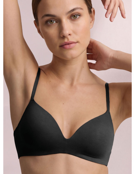 Infiore Naturalfit wireless triangle bra in caramel with black cups and bonded edges worn by a model