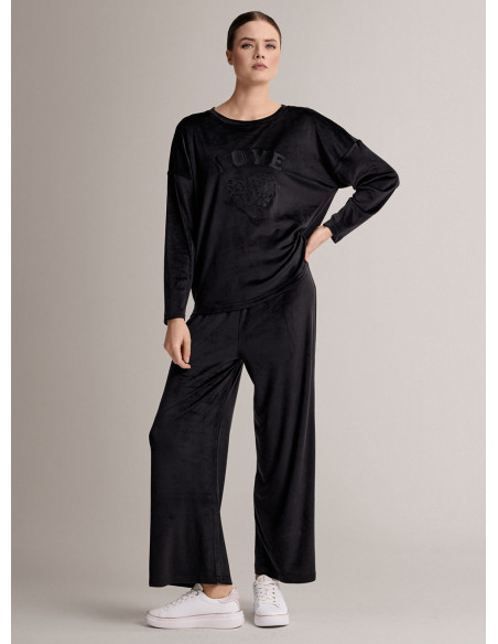 Tuta girocollo in velour morbido e luminoso con maglia a maniche lunghe e pantalone lungo palazzo