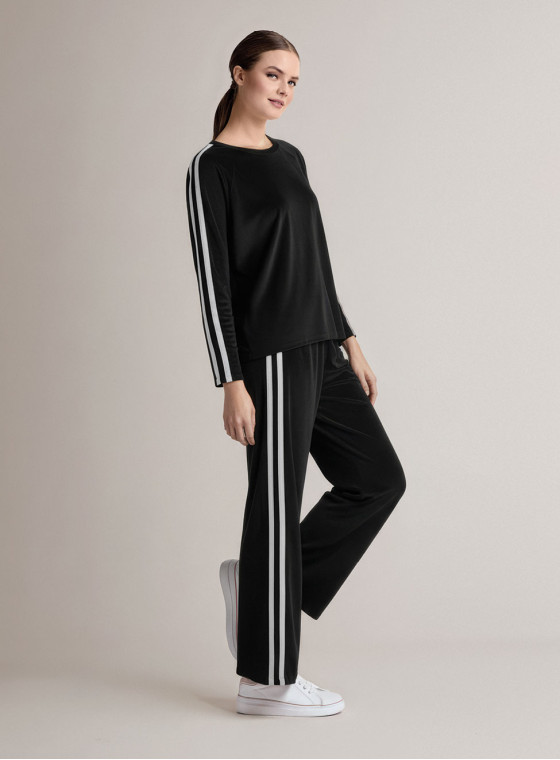 Tuta girocollo in velour morbido e luminoso con maglia a maniche lunghe e pantalone lungo palazzo